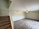 Spacious living room with wood-look floors, ceiling fan, and staircase at 5268 Middle Ct # 111, Orlando, FL 32811