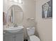 This half bathroom features a modern vanity, round mirror, and stylish decor at 5325 Cypress Reserve Pl, Winter Park, FL 32792