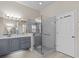 Bathroom with a glass enclosed shower, gray vanity, and white countertop at 5325 Cypress Reserve Pl, Winter Park, FL 32792