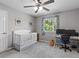 Bright room offering a white crib, workspace desk, and natural light from the window at 5325 Cypress Reserve Pl, Winter Park, FL 32792