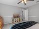 Neutral bedroom features carpet floors, ceiling fan, and reptile habitat with wood stand at 5325 Cypress Reserve Pl, Winter Park, FL 32792