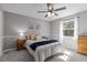This bedroom features neutral walls, a ceiling fan, a window with natural light, and traditional furniture at 5325 Cypress Reserve Pl, Winter Park, FL 32792
