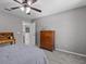 Neutral bedroom features carpet floors, ceiling fan, and wood dresser; bright with natural light at 5325 Cypress Reserve Pl, Winter Park, FL 32792