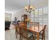 Dining room features a wooden table and chairs with natural light from a large window at 5325 Cypress Reserve Pl, Winter Park, FL 32792