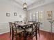 Elegant dining room with a large window, stylish chandelier, and seating for eight at 5325 Cypress Reserve Pl, Winter Park, FL 32792