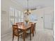 Dining room with a wooden table, chairs and a chandelier at 5325 Cypress Reserve Pl, Winter Park, FL 32792