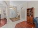 Bright foyer featuring hardwood floors, a decorative rug, and access to various rooms at 5325 Cypress Reserve Pl, Winter Park, FL 32792