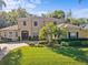 Inviting two-story home boasting a manicured lawn, lush landscaping, and a paver driveway at 5325 Cypress Reserve Pl, Winter Park, FL 32792