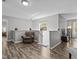Bright hallway featuring wood-look floors, natural light, and a cozy accent chair at 5325 Cypress Reserve Pl, Winter Park, FL 32792