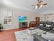 Cozy living room with a leather sofa, tv and a ceiling fan at 5325 Cypress Reserve Pl, Winter Park, FL 32792