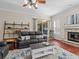 Cozy living room featuring a leather sofa, fireplace and a view of the pool at 5325 Cypress Reserve Pl, Winter Park, FL 32792