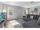 Living room features lots of natural light, a decorative rug and a comfortable gray couch at 5325 Cypress Reserve Pl, Winter Park, FL 32792