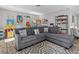 Comfortable living room featuring a gray sectional sofa and a vibrant artwork display at 5325 Cypress Reserve Pl, Winter Park, FL 32792