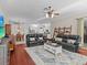 Open-concept living room and dining area with modern furnishings and ample natural light at 5325 Cypress Reserve Pl, Winter Park, FL 32792