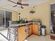 An outdoor kitchen features stone and wood accents, as well as a stainless steel sink at 5325 Cypress Reserve Pl, Winter Park, FL 32792