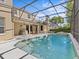 Large pool in screened enclosure surrounded by patio, outdoor kitchen and landscaping at 5325 Cypress Reserve Pl, Winter Park, FL 32792