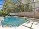 Pool in screened enclosure with lush landscaping; perfect for relaxation and outdoor fun at 5325 Cypress Reserve Pl, Winter Park, FL 32792