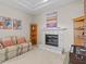 Cozy sitting area with a fireplace, comfortable sofa, and shelving at 5325 Cypress Reserve Pl, Winter Park, FL 32792
