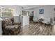 A sitting area with wood floors has two cushioned chairs, a table, and a view of a window at 5325 Cypress Reserve Pl, Winter Park, FL 32792
