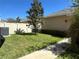 Well-maintained backyard with mature landscaping, walkway, and privacy fence at 5771 Mangrove Cove Ave, Winter Garden, FL 34787