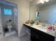 Bathroom features a single vanity with a view into the toilet and shower area at 5771 Mangrove Cove Ave, Winter Garden, FL 34787