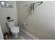 Neutral colored powder room with a modern toilet, towel rack, and base molding at 5771 Mangrove Cove Ave, Winter Garden, FL 34787