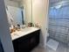 Bathroom with a spacious vanity and a shower featuring patterned curtain at 5771 Mangrove Cove Ave, Winter Garden, FL 34787