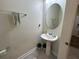 Powder room featuring pedestal sink, and neutral colored walls with modern fixtures at 5771 Mangrove Cove Ave, Winter Garden, FL 34787
