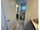 Bright bathroom featuring a toilet, vanity, tiled floor and window at 5771 Mangrove Cove Ave, Winter Garden, FL 34787