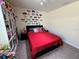 Bedroom featuring a full bed, dark grey carpet, and decorated walls at 5771 Mangrove Cove Ave, Winter Garden, FL 34787