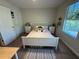 Comfortable bedroom with natural light, a bed, and matching nightstands at 5771 Mangrove Cove Ave, Winter Garden, FL 34787