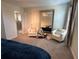 Bright bedroom features seating area, large mirror, and neutral tones, offering a comfortable space at 5771 Mangrove Cove Ave, Winter Garden, FL 34787