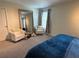 Bright bedroom features seating area, large mirror, and neutral tones, offering a comfortable space at 5771 Mangrove Cove Ave, Winter Garden, FL 34787