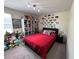 View of bedroom decorated with collectibles, a full bookcase, and a bed with black accents at 5771 Mangrove Cove Ave, Winter Garden, FL 34787