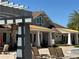 Resort-style clubhouse with covered patio seating and views of lush landscaping at 5771 Mangrove Cove Ave, Winter Garden, FL 34787