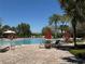 Large community pool surrounded by lush landscaping and comfortable lounge seating at 5771 Mangrove Cove Ave, Winter Garden, FL 34787