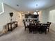 Open concept dining room and kitchen, with modern light fixtures and dining table at 5771 Mangrove Cove Ave, Winter Garden, FL 34787