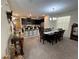 Open concept dining and kitchen area, featuring dining table with dark wood finish at 5771 Mangrove Cove Ave, Winter Garden, FL 34787