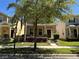 Charming home with a well-maintained lawn and mature landscaping, including a shade tree at 5771 Mangrove Cove Ave, Winter Garden, FL 34787