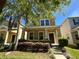 Beautiful two-story home featuring a cozy front porch and lush landscaping at 5771 Mangrove Cove Ave, Winter Garden, FL 34787