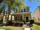 Attractive home with lush landscaping, a welcoming front porch, and a well-manicured lawn at 5771 Mangrove Cove Ave, Winter Garden, FL 34787