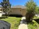 Home exterior with green lawn, walkway and vibrant, mature landscaping at 5771 Mangrove Cove Ave, Winter Garden, FL 34787
