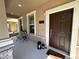 Inviting front porch with a small seating area and stylish lanterns near the entryway at 5771 Mangrove Cove Ave, Winter Garden, FL 34787