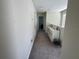 Well-lit upstairs hallway with carpet, a white dresser, and views into adjacent rooms through open doorways at 5771 Mangrove Cove Ave, Winter Garden, FL 34787