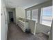 Well-lit upstairs hallway with carpet, a white dresser, and views into adjacent rooms through open doorways at 5771 Mangrove Cove Ave, Winter Garden, FL 34787
