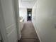 Hallway with carpet floor and view into another room at 5771 Mangrove Cove Ave, Winter Garden, FL 34787