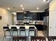 Spacious kitchen boasting black cabinets, stainless steel appliances, and a large island with seating at 5771 Mangrove Cove Ave, Winter Garden, FL 34787