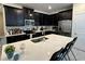 Modern kitchen featuring black cabinetry, stainless steel appliances, and quartz countertops at 5771 Mangrove Cove Ave, Winter Garden, FL 34787