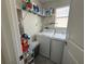 Functional laundry room with washer, dryer, and ample storage space on shelves at 5771 Mangrove Cove Ave, Winter Garden, FL 34787