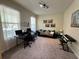 View of the living room with neutral carpet, computer desk, sofa, and natural lighting at 5771 Mangrove Cove Ave, Winter Garden, FL 34787
